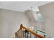 Staircase with decorative chandelier, wood railing and iron spindles, and view of the entryway at 3110 Royal Troon, Woodstock, GA 30189