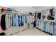 This walk-in closet features ample storage for clothing, shoes and accessories on multiple racks at 3110 Royal Troon, Woodstock, GA 30189