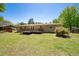 Expansive backyard with a deck, lush green grass, and mature trees, creating a serene outdoor space at 4284 Carlos Ct, Powder Springs, GA 30127