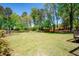 Overlooking the spacious backyard with mature trees and partial fencing at the property line at 4284 Carlos Ct, Powder Springs, GA 30127