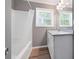 Bathroom featuring a shower, wood look flooring, granite vanity, and a mirror with overhead lighting at 4284 Carlos Ct, Powder Springs, GA 30127