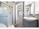 Bathroom with a walk-in shower, modern sink, and fixtures, offering a blend of style and functionality at 4284 Carlos Ct, Powder Springs, GA 30127
