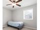 Bright bedroom featuring a ceiling fan, neutral walls, and a window providing natural light at 4284 Carlos Ct, Powder Springs, GA 30127