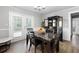 Bright dining room with a marble table, modern furnishings, and natural light from a glass patio door at 4284 Carlos Ct, Powder Springs, GA 30127