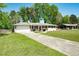 Charming single-story house with a well-manicured lawn, a driveway, and attached garage at 4284 Carlos Ct, Powder Springs, GA 30127