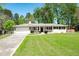 Traditional home featuring a spacious front lawn and attached two-car garage at 4284 Carlos Ct, Powder Springs, GA 30127