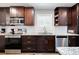 A charming kitchen featuring stainless steel appliances, stylish cabinets, and granite countertops at 4284 Carlos Ct, Powder Springs, GA 30127