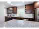 Well-lit kitchen with granite countertops, stainless steel appliances, and dark wood cabinetry at 4284 Carlos Ct, Powder Springs, GA 30127