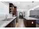 Open kitchen featuring an island, granite countertops, stainless appliances, and seamless flow to living area at 4284 Carlos Ct, Powder Springs, GA 30127