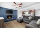 Open-concept living room featuring a fireplace, hardwood floors, and modern decor at 4284 Carlos Ct, Powder Springs, GA 30127
