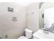 Cozy bathroom with tiled walls, a toilet, a sink, mirror and decorative touches at 432 Ira Sw St # 201, Atlanta, GA 30312