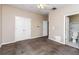 Neutral bedroom featuring carpet, a ceiling fan, and an attached bathroom with toilet and shower at 432 Ira Sw St # 201, Atlanta, GA 30312