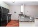 Compact kitchen features granite countertops, modern appliances, and sleek finishes, great flow with wood floors at 432 Ira Sw St # 201, Atlanta, GA 30312