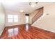 Open concept living room with gleaming wood floors and modern decorative lighting, with backyard door at 432 Ira Sw St # 201, Atlanta, GA 30312