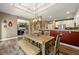 Open concept dining room with modern chandelier, hardwood floors, and view to living room at 625 Aunt Lucy Sw Ln # 61, Smyrna, GA 30082