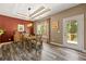 Dining area features wood table set, modern chandelier, and access to patio at 625 Aunt Lucy Sw Ln # 61, Smyrna, GA 30082