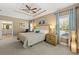 Spacious bedroom with tray ceiling, ceiling fan, ensuite bathroom, and large windows for natural light at 625 Aunt Lucy Sw Ln # 61, Smyrna, GA 30082