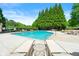 Community pool with lounge chairs and lush landscaping on a beautiful sunny day at 625 Aunt Lucy Sw Ln # 61, Smyrna, GA 30082