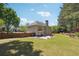 Expansive backyard with a manicured lawn, patio area, and privacy fence at 715 Aronson Lake Ct, Roswell, GA 30075