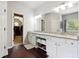 Bright bathroom with double vanity, granite countertops, and hardwood floors at 715 Aronson Lake Ct, Roswell, GA 30075