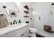 Modern bathroom with glass shower, herringbone tile, and floating shelves at 715 Aronson Lake Ct, Roswell, GA 30075