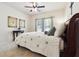 Cozy bedroom featuring a ceiling fan, carpeted floors, and warm natural light from the windows at 715 Aronson Lake Ct, Roswell, GA 30075