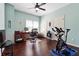 Bedroom featuring hardwood floors, ceiling fan, natural light, exercise bike and desk at 715 Aronson Lake Ct, Roswell, GA 30075