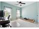 Bright bedroom with a ceiling fan, natural light, and neutral carpet flooring at 715 Aronson Lake Ct, Roswell, GA 30075