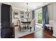 Formal dining room with hardwood floors, chandelier, and large windows offering natural light at 715 Aronson Lake Ct, Roswell, GA 30075