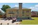 A large backyard featuring a patio area with outdoor seating and a well-manicured lawn at 715 Aronson Lake Ct, Roswell, GA 30075