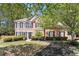 Beautiful brick home with black shutters, lovely landscaping and healthy green grass at 715 Aronson Lake Ct, Roswell, GA 30075