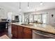 Open-concept kitchen with granite island, pendant lighting, and stainless appliances at 715 Aronson Lake Ct, Roswell, GA 30075
