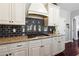 Modern kitchen design with granite counters, white cabinets, and gas cooktop at 715 Aronson Lake Ct, Roswell, GA 30075