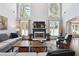 Bright living room featuring a fireplace, hardwood floors, and large windows at 715 Aronson Lake Ct, Roswell, GA 30075