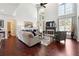 Spacious living room with hardwood floors, fireplace, soaring ceilings, and large windows at 715 Aronson Lake Ct, Roswell, GA 30075