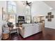 Bright living room with hardwood floors, fireplace, high ceilings, and large windows at 715 Aronson Lake Ct, Roswell, GA 30075
