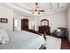 Large primary bedroom with dark wood floors, trey ceiling, and staircase access at 715 Aronson Lake Ct, Roswell, GA 30075