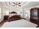 Spacious primary bedroom with trey ceiling, wood floors, ceiling fan and ensuite bathroom at 715 Aronson Lake Ct, Roswell, GA 30075