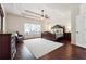 Spacious main bedroom with a trey ceiling, wood floors, a ceiling fan and lots of natural light at 715 Aronson Lake Ct, Roswell, GA 30075