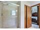 Bathroom featuring glass enclosed shower and doorway into the main bedroom at 1423 Fairfield Sw Dr, Lilburn, GA 30047