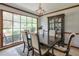 Traditional dining room with dark wood table and chairs, complemented by a large window and decorative lighting fixture at 1423 Fairfield Sw Dr, Lilburn, GA 30047