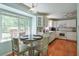 Bright eat-in kitchen featuring stainless steel appliances, hardwood floors, and large windows overlooking backyard at 1423 Fairfield Sw Dr, Lilburn, GA 30047