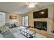 Inviting living room with a fireplace, large TV, comfortable seating, and french doors leading to the outdoors at 1423 Fairfield Sw Dr, Lilburn, GA 30047