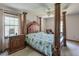 Spacious main bedroom featuring a four-poster bed, decorative touches, and lots of natural light at 1423 Fairfield Sw Dr, Lilburn, GA 30047