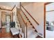 Carpeted staircase with wood banister and trim, leading to the second floor, visible from the home's entryway at 1423 Fairfield Sw Dr, Lilburn, GA 30047