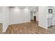 Finished basement with new flooring, white walls, and a partial view of the kitchen area at 160 Oglesby Bridge Rd, Conyers, GA 30094