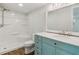 Bathroom featuring custom vanity, large mirror, and updated tub and shower combo at 160 Oglesby Bridge Rd, Conyers, GA 30094