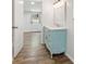 Bathroom features a blue vanity, white countertops, and a doorway to another room at 160 Oglesby Bridge Rd, Conyers, GA 30094