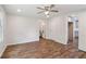 Bedroom featuring wood-look floors, ceiling fan, and access to the kitchen and bathroom at 160 Oglesby Bridge Rd, Conyers, GA 30094