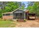 Ranch style home featuring an open carport and inviting screened porch, set on a verdant lot at 160 Oglesby Bridge Rd, Conyers, GA 30094